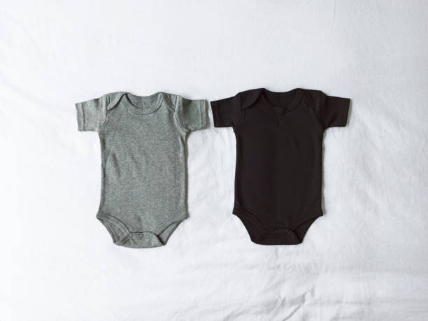Gray and black baby onesies set on a white textile background