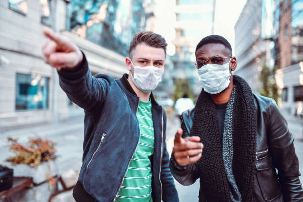 istock Male Multi Ethnic Friends Looking For Anti Pollution Demonstration Gathering 1190070055