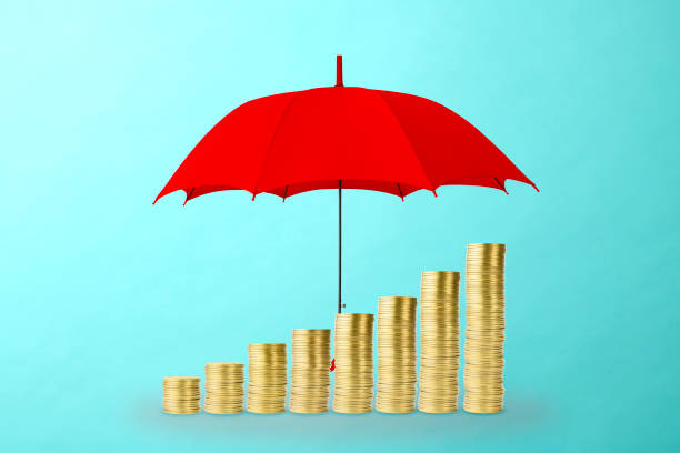 istock Stair-shaped gold coins under the red umbrella. 1190075606