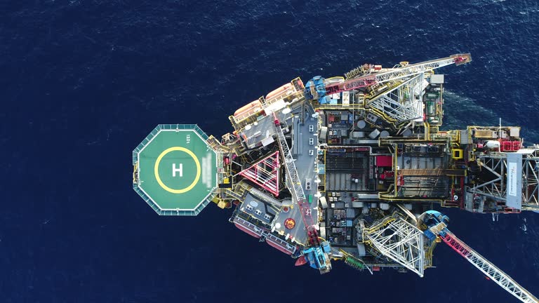 Aerial shot of off shore oil platforms working close up day time