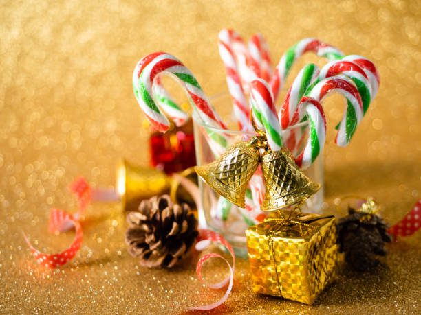 istock Christmas candy sticks on glass with silver bokeh background. 1190081684