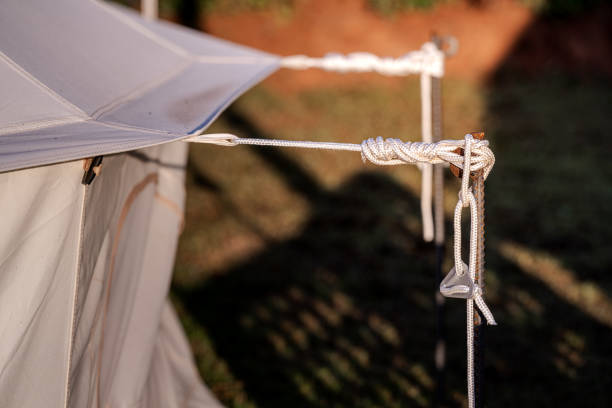 istock Tent camping anchor and rope knot. 1190082945