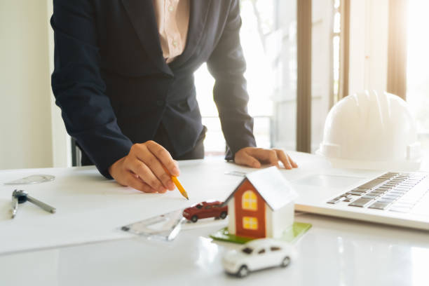 istock Architect or engineer working in office with blueprints,engineer inspection in workplace for architectural plan,sketching a construction project ,selective focus,Business construction concept. 1190085422