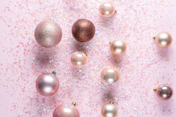 istock Elegant christmas tree balls on pink background decorated with tinsel. top view 1190087243