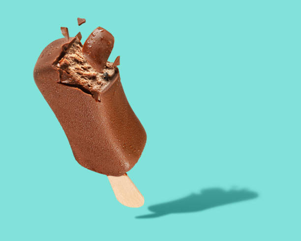 istock Chocolate truffle ice cream popsicle with coating on green background 1190089272