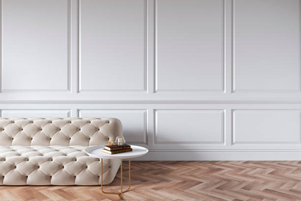 istock Modern classic white interior with capitone chester sofa, coffee table, wood floor, mouldings. 3d render interior mock up. 1190093152