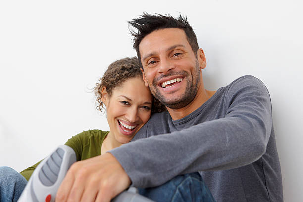 istock Happy young couple sitting together holding drill on white background 119009360