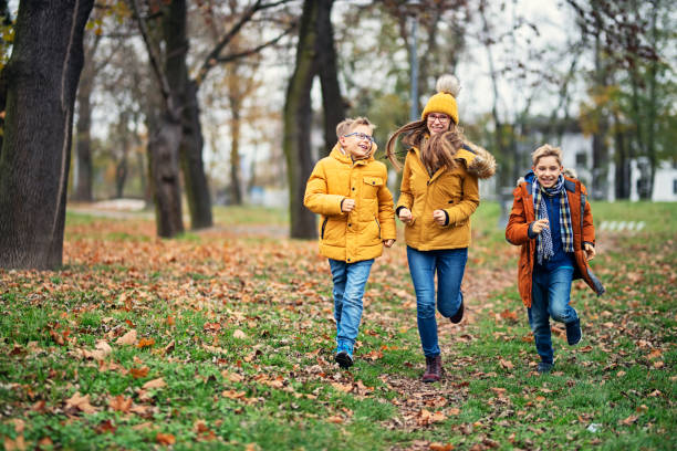 istock Happy children running in autumn park 1190094966