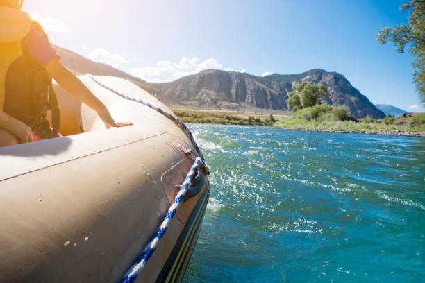 istock Passengers on Rafting Boat Traveling Down River 1190095638
