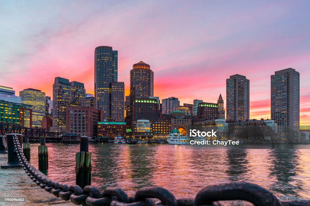 Boston skyline and Fort Point Channel at sunset as viewed fantastic twilight or dusk time from Fan Pier Park in Boston, Massachusetts, USA. United state downtown beautiful colorful skyline. Boston - Massachusetts Stock Photo