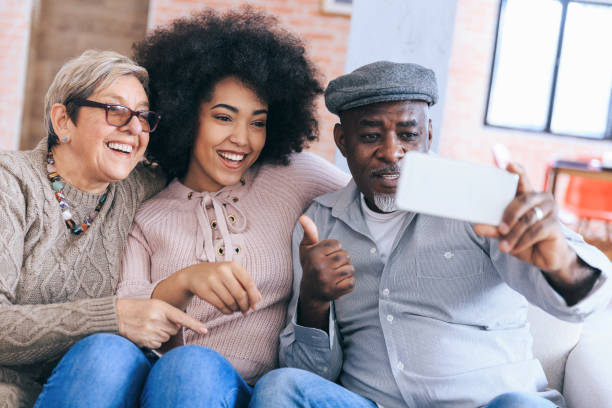 istock Multi-ethnic family having fun at home using smart phone 1190099551