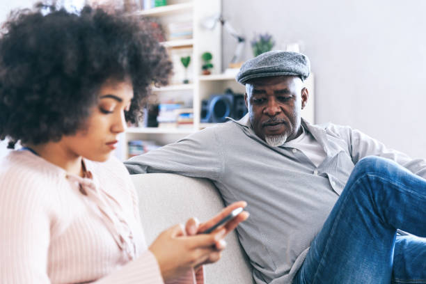 istock Father and daughter using smart phone at home 1190099552