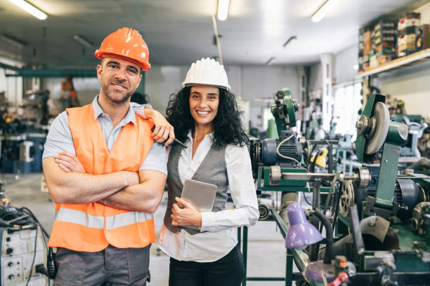 istock Manager and worker standing in industrial factory 1190099742