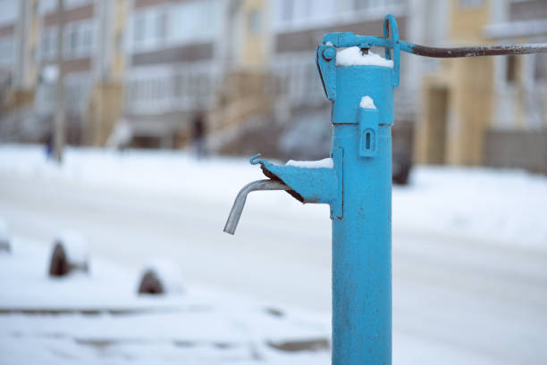 Old street water pipe stand on modern living house background.