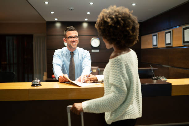 istock Woman register on hotel's reception 1190100521