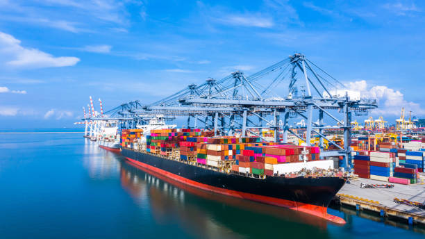 istock Container cargo ship at industrial port in import export business logistic and transportation of international by container cargo ship in the open sea. 1190102941