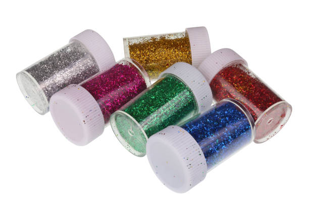 Transparent jars with multi-colored metal sparkles tinsel  for Christmas decoration. Isolated stock photo