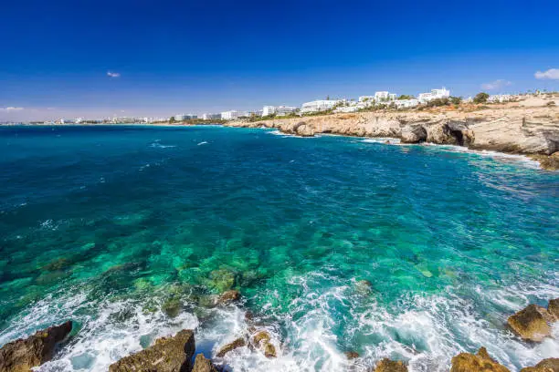 Rocky shore, clear turquoise sea water and blue sky in Ayia-Napa, Cyprus.