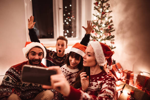 istock friends using smartphones at christmas 1190107892