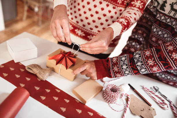 istock couple preparing christmas presents 1190107917