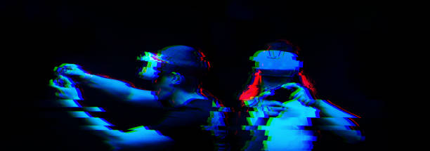 istock Couple with virtual reality headset are playing game. Image with glitch effect. 1190108050