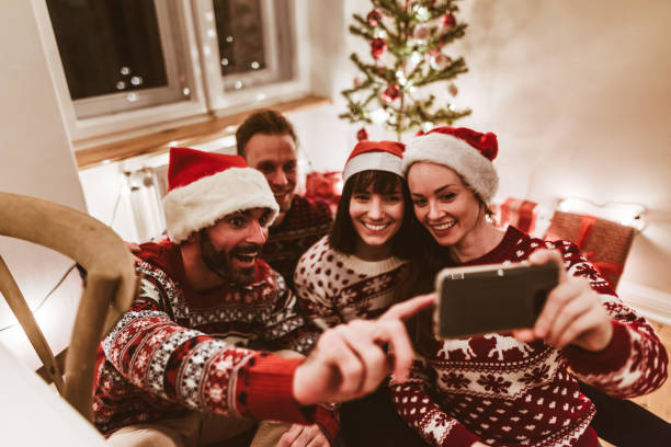 istock friends using smartphones at christmas 1190110220