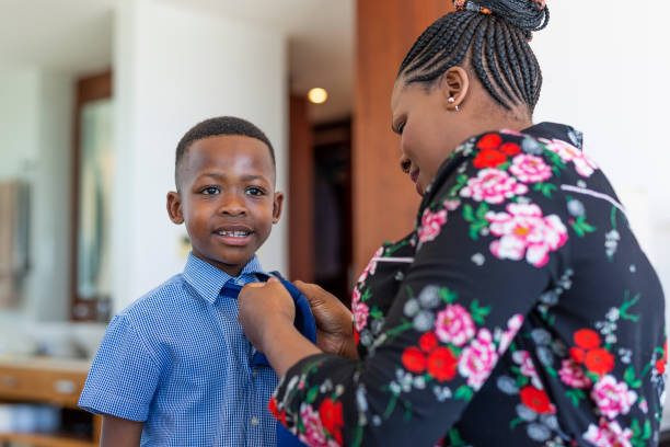 istock Mother Helping Young African Boy to Get Ready for School 1190110276