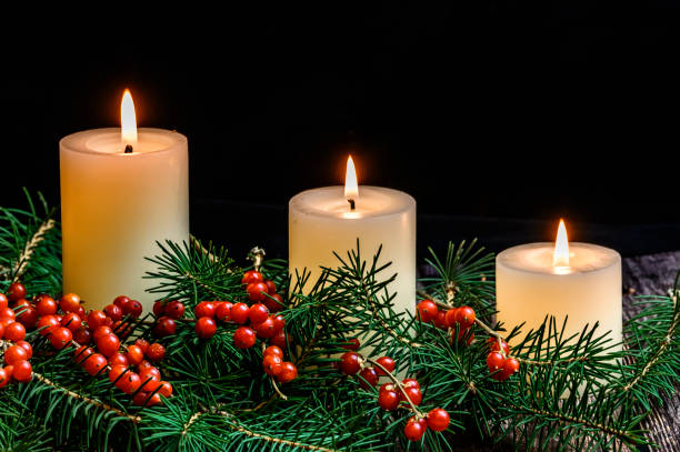 istock Christmas candle on black background 1190120831