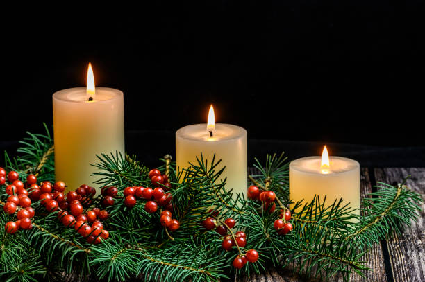 istock Christmas candle on black background 1190120911