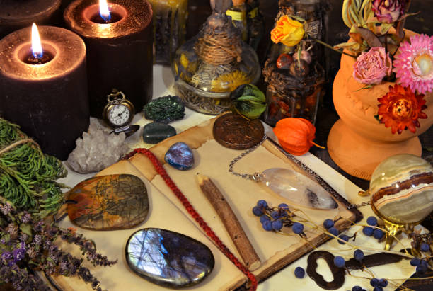 istock Still life with magic objects, open diary, gemstone, crystal ball and burning candle on witch table. 1190121814
