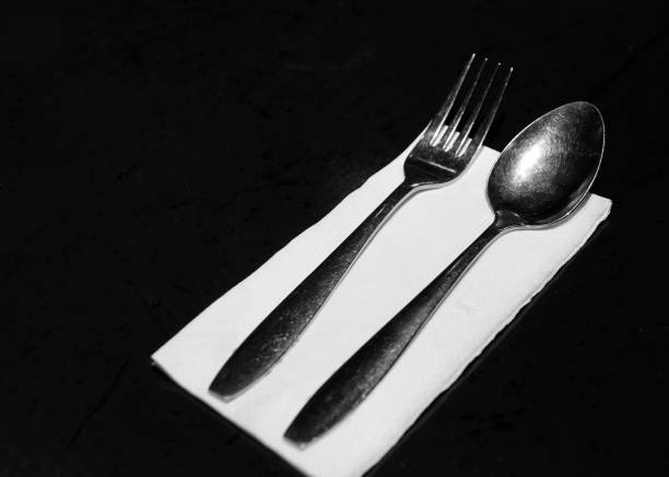 istock fork and knives with tissue paper  in restaurant, Table place setting 1190122144