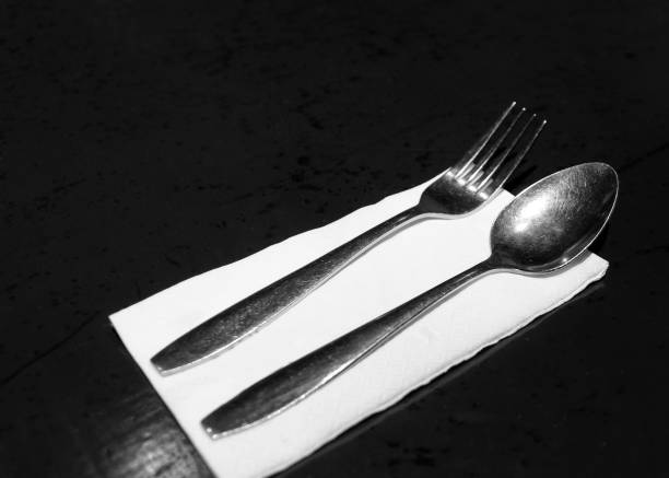 istock fork and knives with tissue paper  in restaurant, Table place setting 1190122263