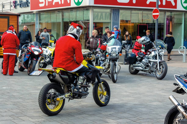 nyiregyhaza, hungaria - 07 DEC 2014: people dressed as santa claus on motorcycles. annual santa-themed charity fundraiser event on second sunday of advent organized by local biker club
