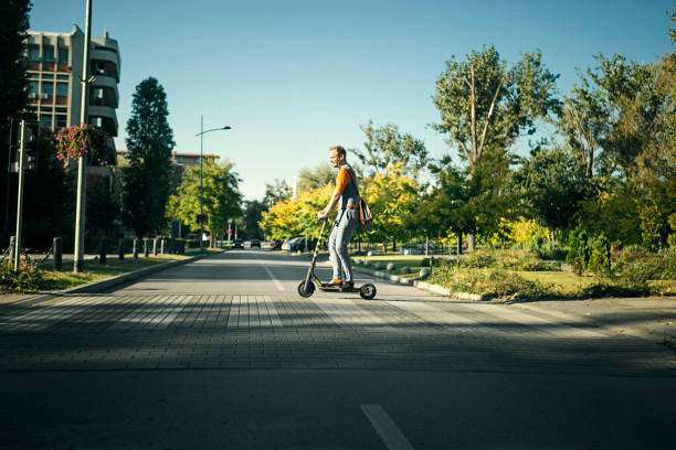 istock Hipster riding a scooter ,riding through zebra crossing 1190124214