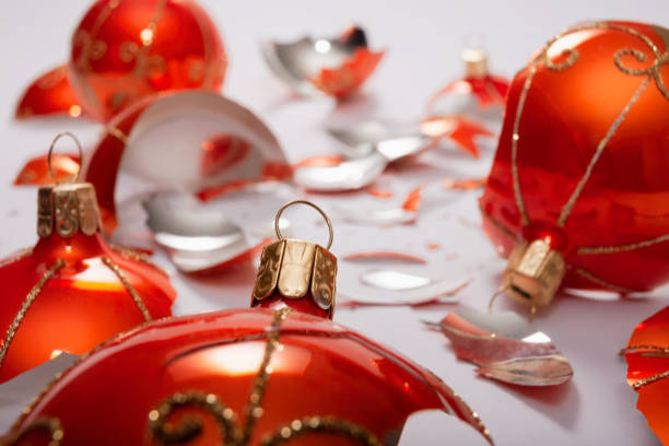 istock Bright orange, glass Christmas baubles broken, scattered fragments on a white background 1190124470