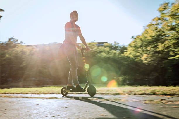 istock Driving a scooter against sunset 1190124554