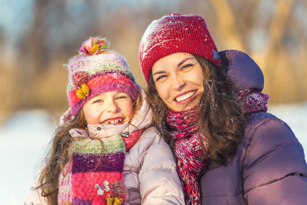 istock Mother and daughter playing in winter park 1190126176