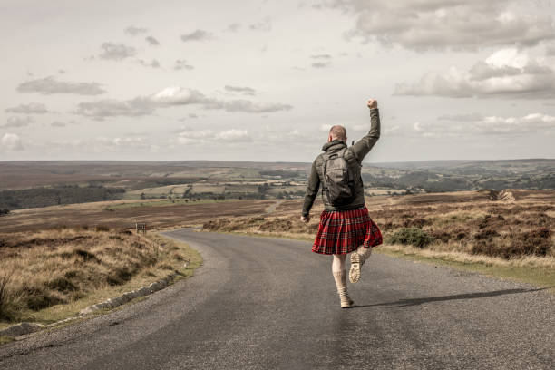 Male hiker wearing a kilt in the countryside Male hiker man wearing a kilt enjoying some free time and fresh air outdoors on a beautiful day kilt stock pictures, royalty-free photos & images