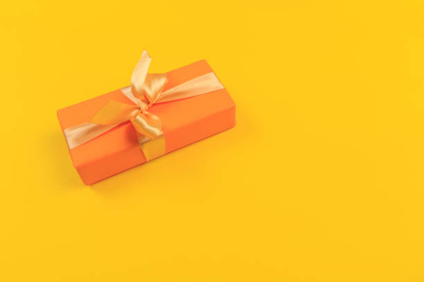 istock Gift box with ribbon and bow on color background and space for text. Top view 1190127939