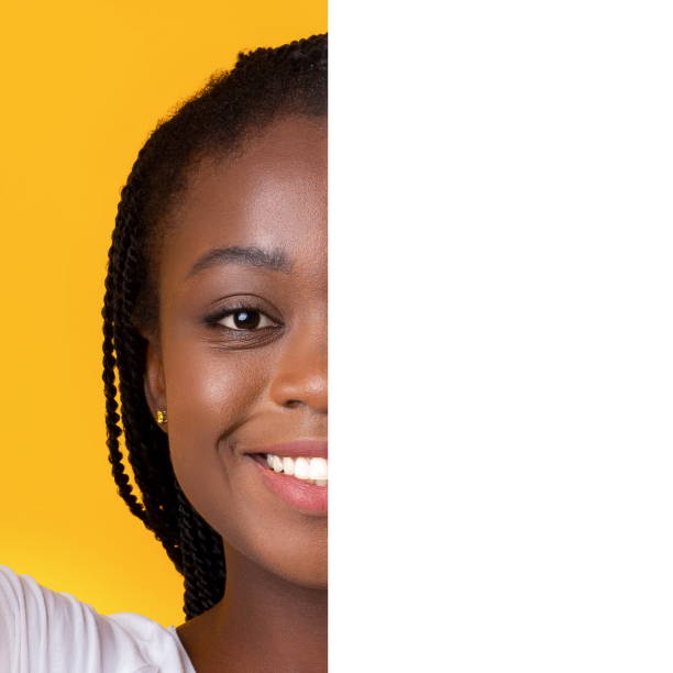 istock Smiling girl covering half of face with blank white board 1190128131