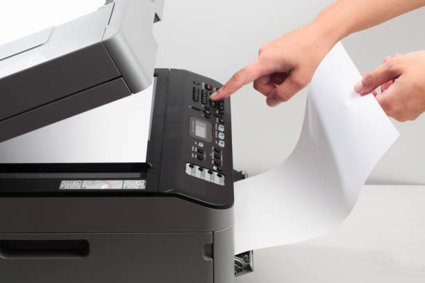 istock Hand press button on panel of printer. printer scanner laser office copy machine supplies start concept 1190128144