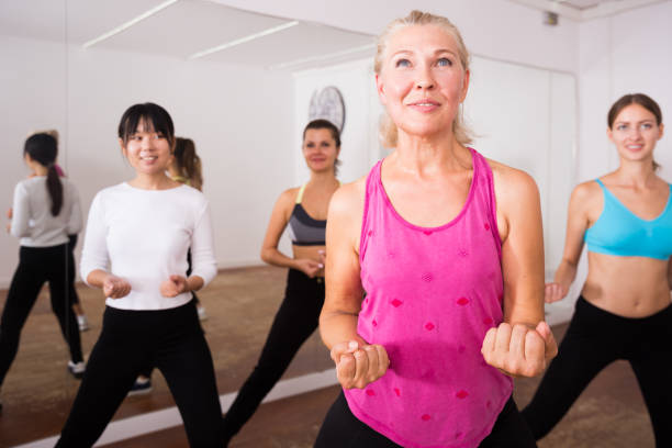 istock Fitness women practicing zumba movements 1190128486