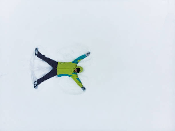 istock overhead view of man making snow angel 1190129955
