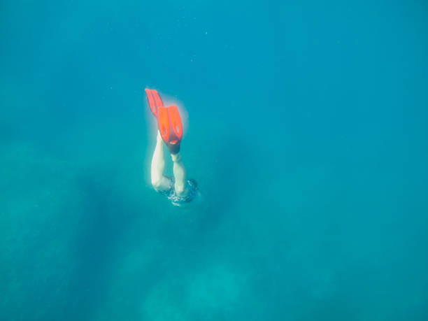 istock man in underwater in flippers looking at sea bottom 1190129966