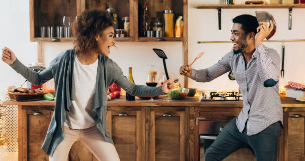 istock Funny couple fighting with utensils tools in kitchen 1190131081
