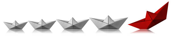 istock Leadership Concept - Paper boats on white background 1190131294