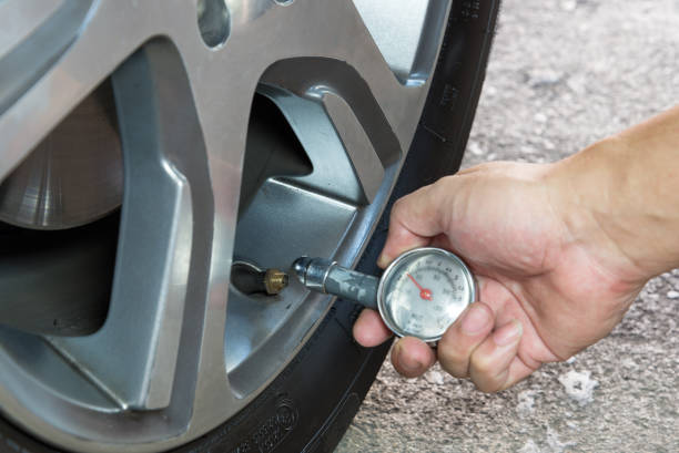 istock Car tire pressure check using air pressure guage 1190132837