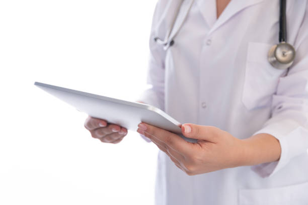 istock Woman doctor using digital tablet on white background 1190132918