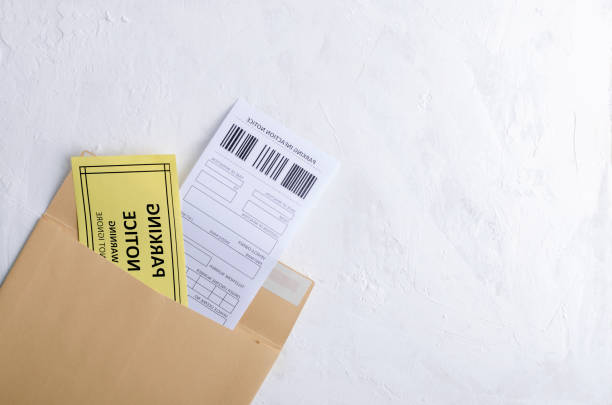 istock Parking notice and parking infaction notice in an envelope on the white surface.Space for text 1190133805