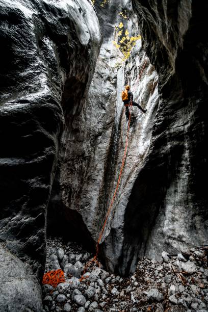 istock Canyoneer descending down the rope into a cave 1190133910